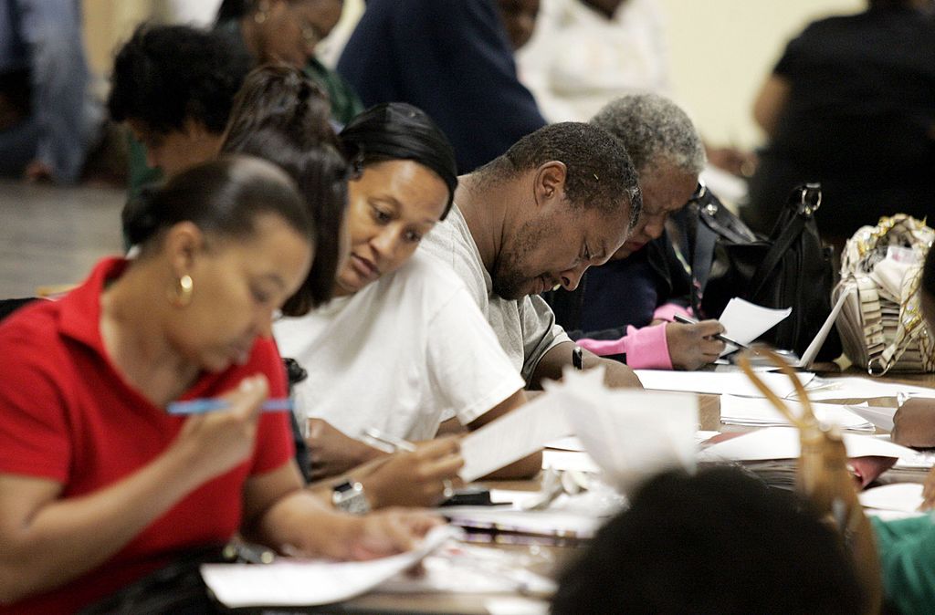 Families fill out school registration forms